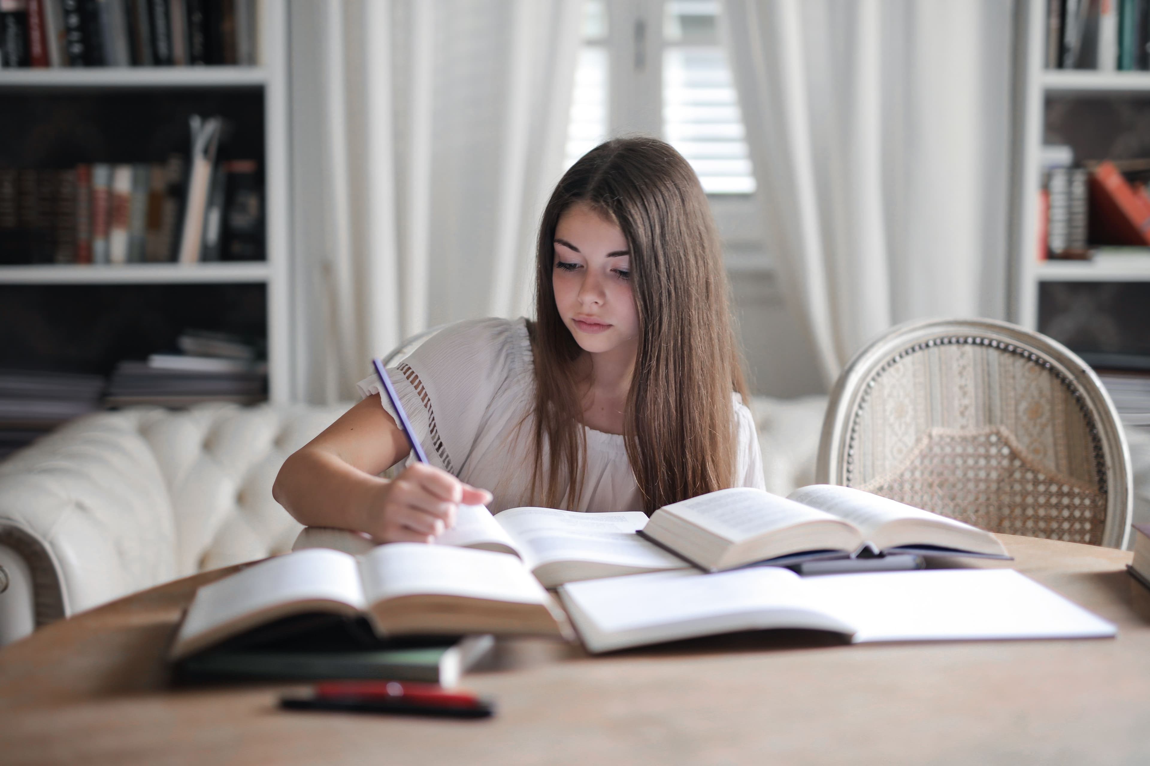 Writer studying open books at a desk