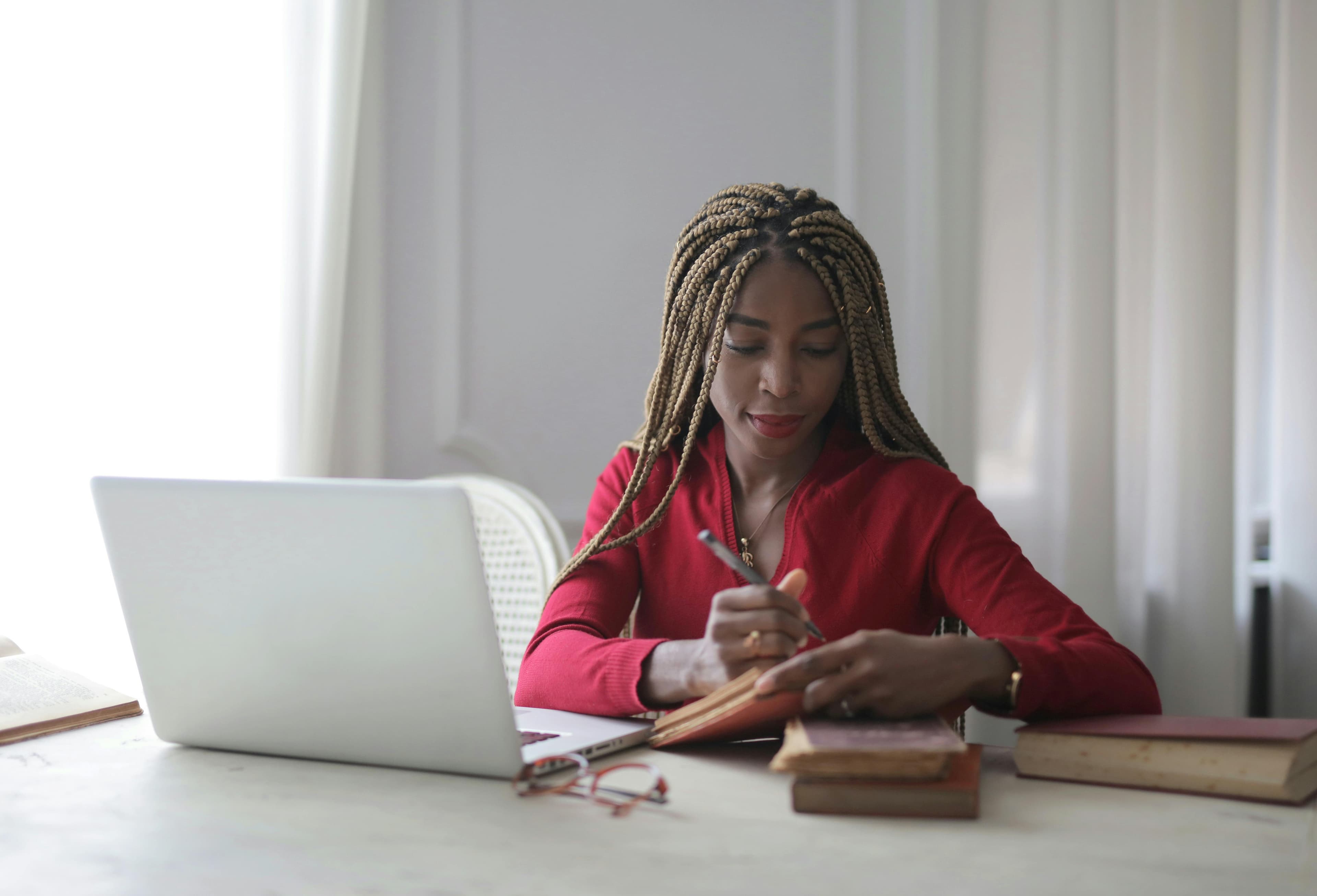 Writer working thoughtfully in a bright creative space